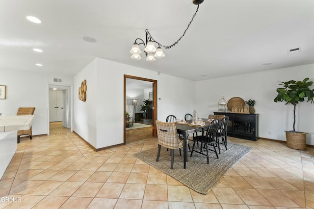 tiled dining space with an inviting chandelier