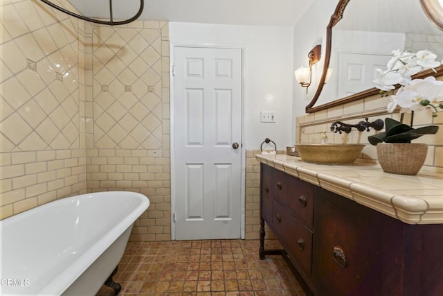 bathroom with vanity, tile walls, and a washtub