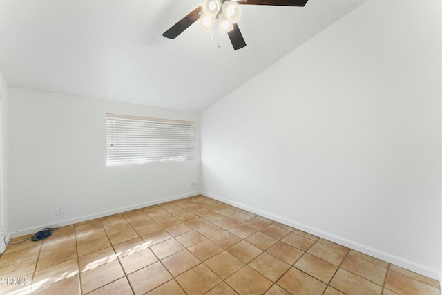 spare room with ceiling fan, lofted ceiling, and light tile patterned floors