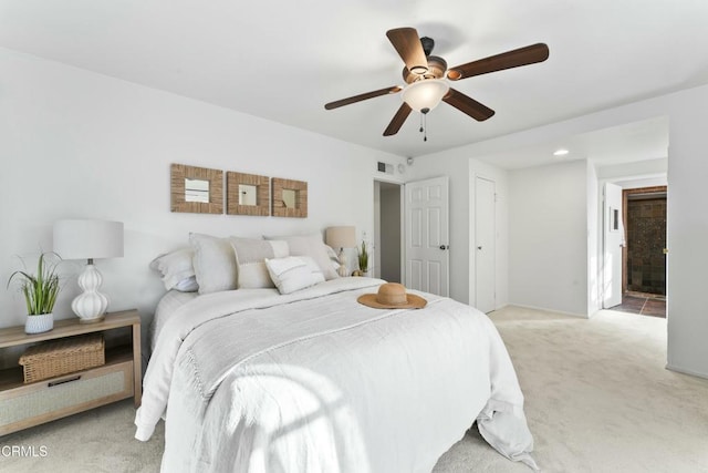 bedroom with ceiling fan and light colored carpet