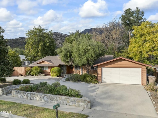 ranch-style home with a mountain view and a garage