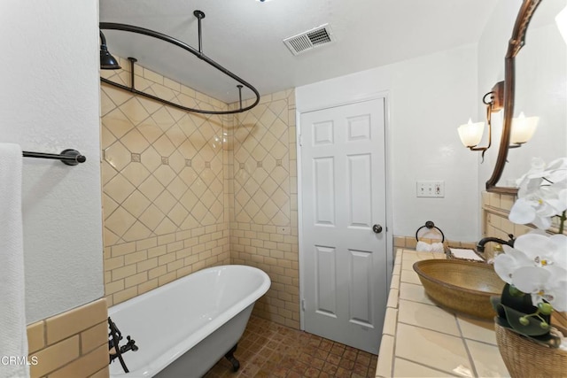 bathroom featuring tile patterned flooring, vanity, separate shower and tub, and tile walls