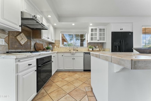 kitchen with white cabinets, plenty of natural light, and black appliances