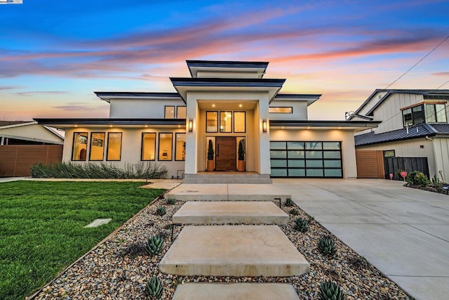 view of front facade with a lawn and a garage