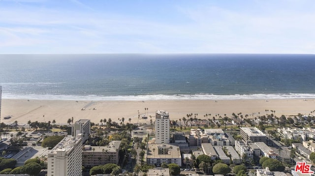 birds eye view of property with a beach view and a water view