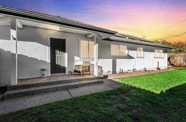 exterior entry at dusk with a yard