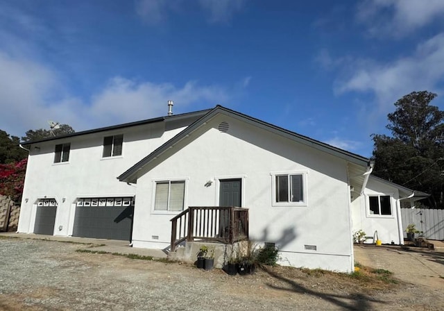 back of property with a garage