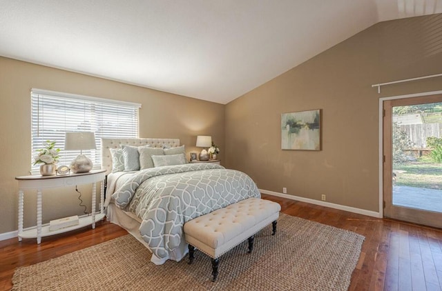 bedroom with access to outside, vaulted ceiling, dark hardwood / wood-style floors, and multiple windows