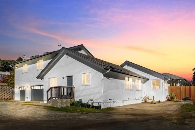 property exterior at dusk featuring a garage