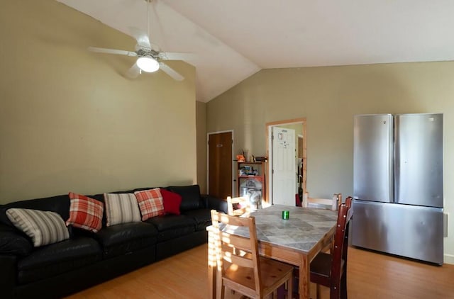 dining room with vaulted ceiling, ceiling fan, and light hardwood / wood-style floors