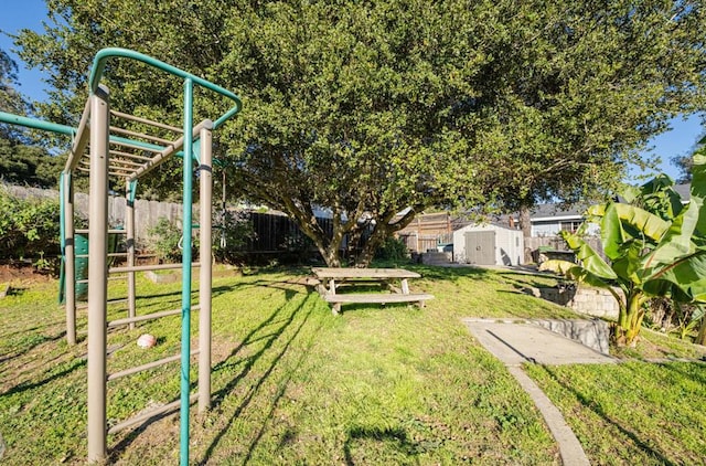 view of yard featuring a playground and a storage unit