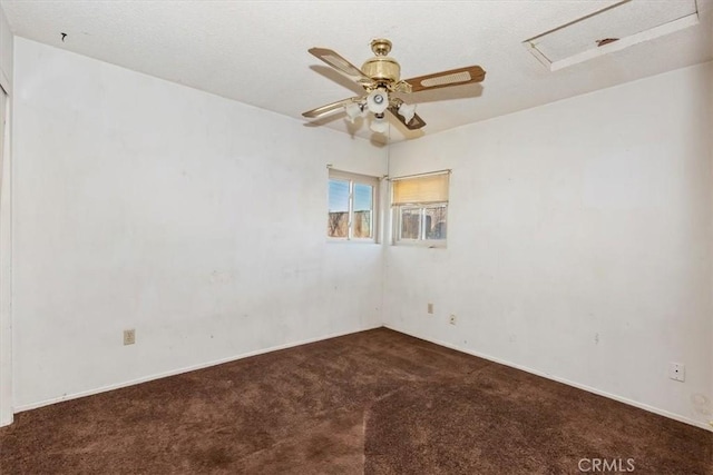 unfurnished room featuring dark colored carpet and ceiling fan