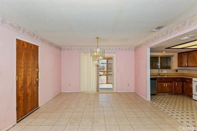 interior space with a chandelier, sink, light tile patterned floors, and a textured ceiling