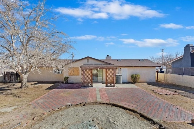 ranch-style house featuring central AC unit and a patio area