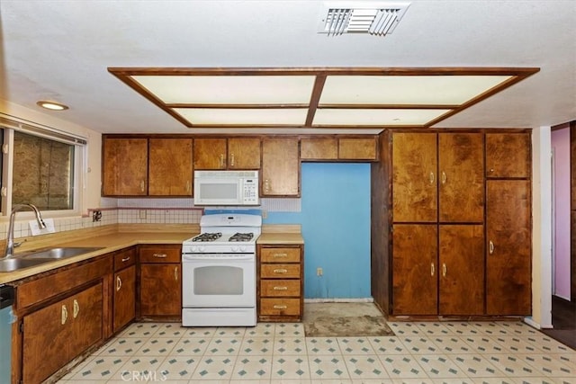 kitchen featuring sink and white appliances