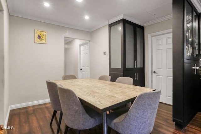 dining space featuring dark wood-type flooring and ornamental molding