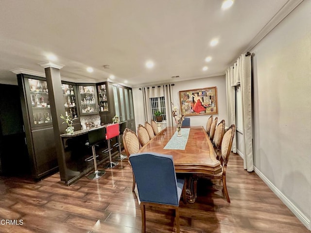 dining room featuring ornamental molding and dark hardwood / wood-style floors