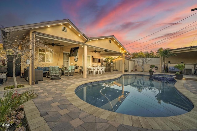 view of swimming pool featuring ceiling fan, a patio, an in ground hot tub, and an outdoor living space