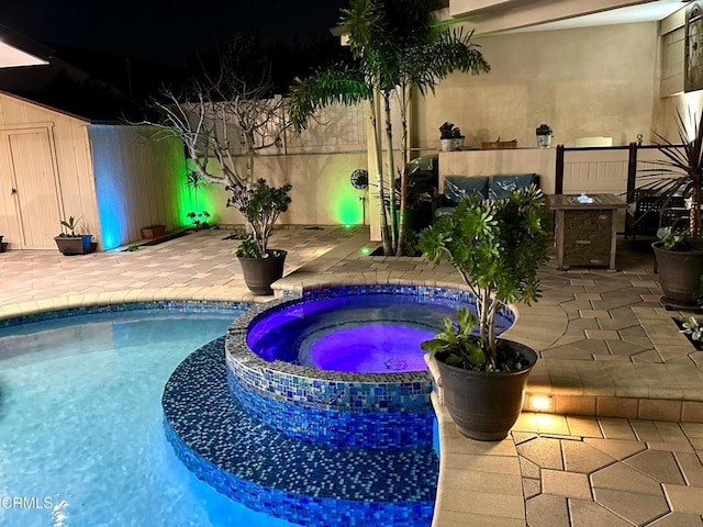 view of swimming pool with a patio area and an in ground hot tub