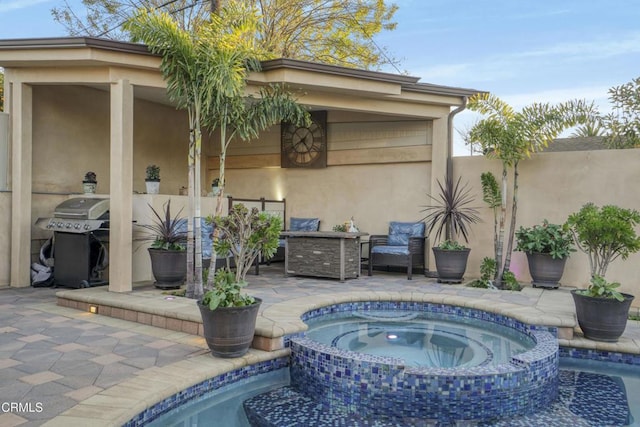 view of pool with an in ground hot tub, a patio area, and grilling area