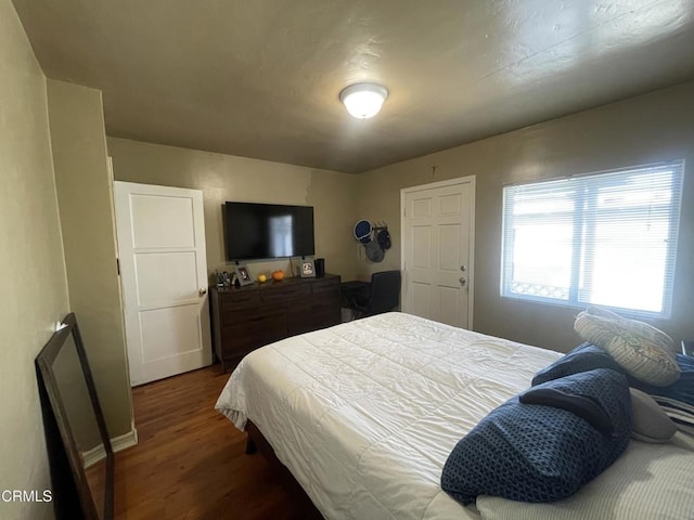 bedroom featuring dark hardwood / wood-style flooring