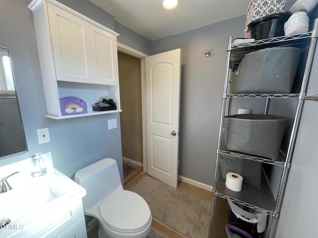 bathroom featuring toilet and vanity