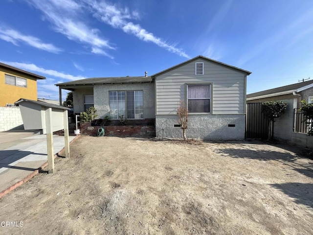 view of front of house featuring a storage unit