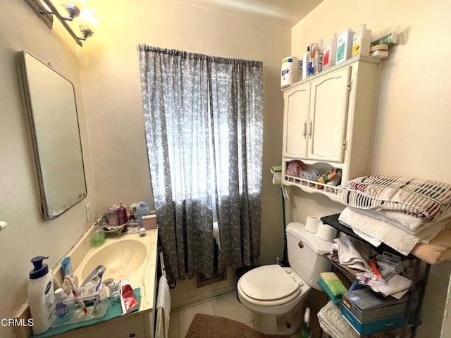 bathroom featuring tile patterned floors, vanity, and toilet