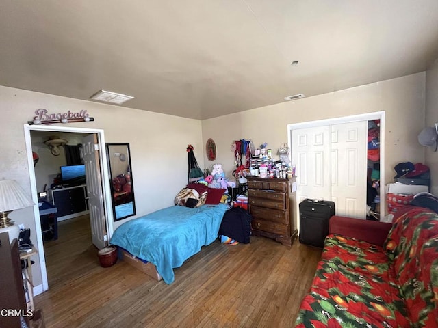 bedroom featuring hardwood / wood-style floors and a closet