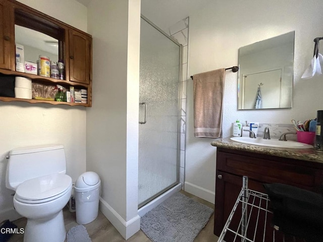 bathroom with an enclosed shower, vanity, toilet, and hardwood / wood-style flooring