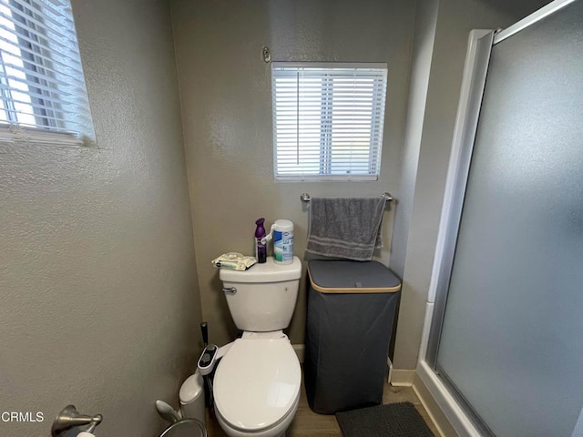 bathroom featuring toilet and walk in shower