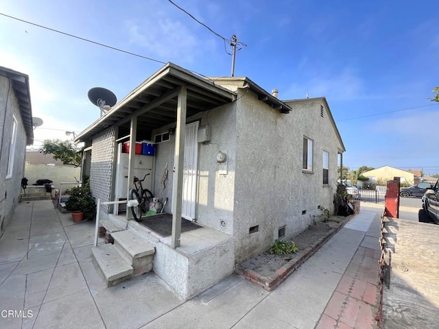 136 S Roosevelt Ave, Oxnard, CA 93030 - rear view of house with stucco siding and crawl space