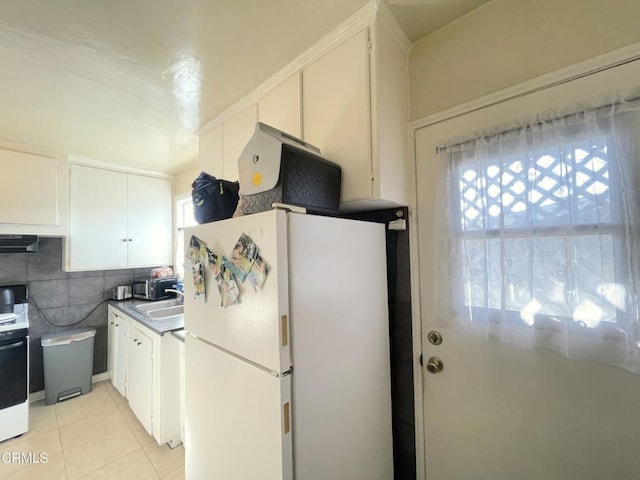 136 S Roosevelt Ave, Oxnard, CA 93030 - kitchen with freestanding refrigerator, healthy amount of natural light, and white cabinets