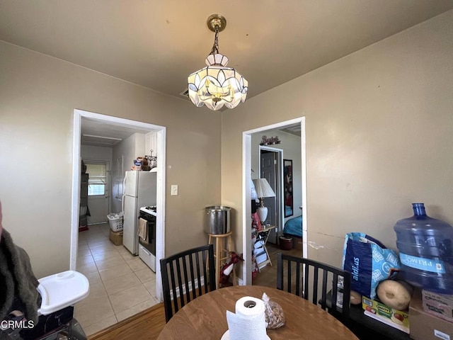 136 S Roosevelt Ave, Oxnard, CA 93030 - dining area with a chandelier and light tile patterned floors