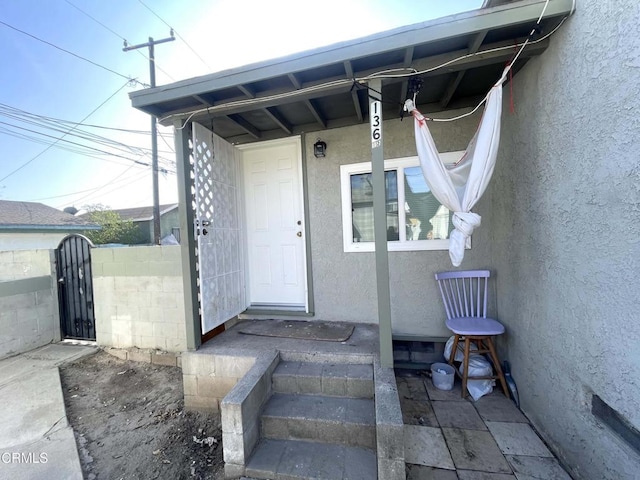 136 S Roosevelt Ave, Oxnard, CA 93030 - view of exterior entry with stucco siding and a gate