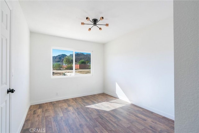 empty room with wood finished floors and baseboards