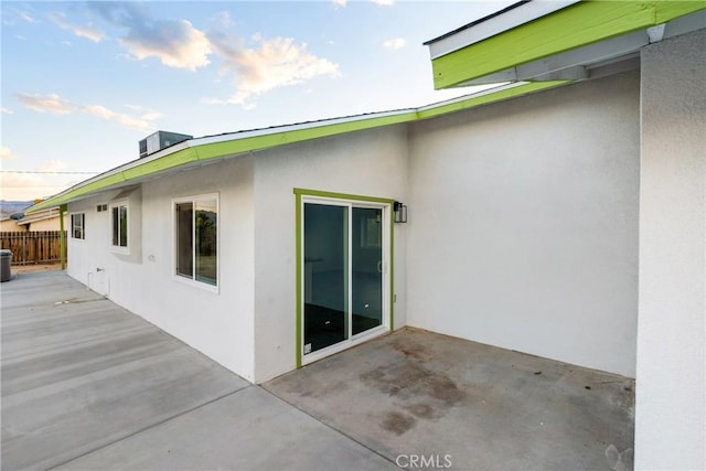 back of property featuring stucco siding, a patio area, and fence