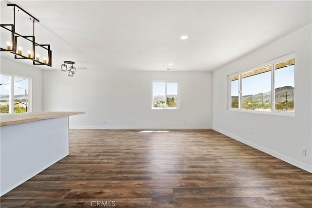 interior space featuring recessed lighting, dark wood-style floors, and baseboards