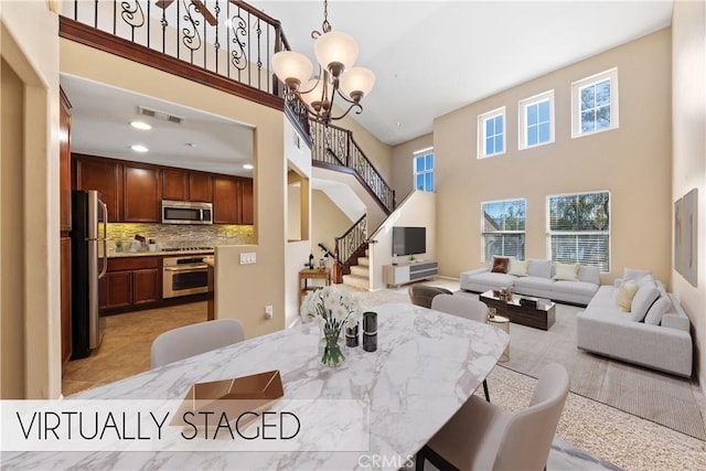 dining area featuring a high ceiling and a notable chandelier