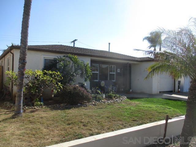 ranch-style home with a front lawn and a garage