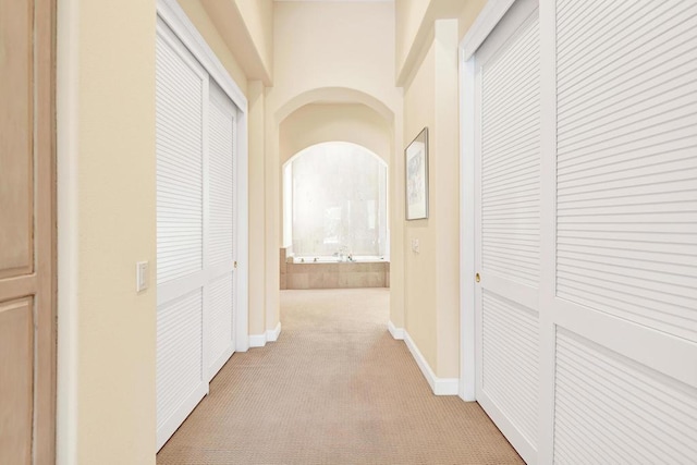 hallway with light colored carpet