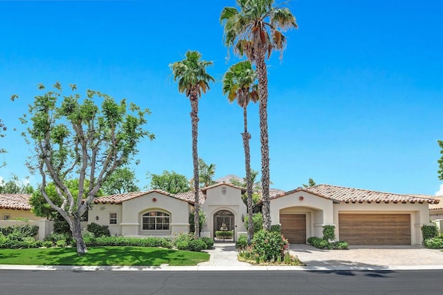 mediterranean / spanish-style home featuring a garage