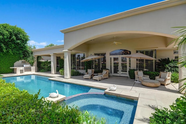 view of swimming pool with ceiling fan, exterior kitchen, and a patio