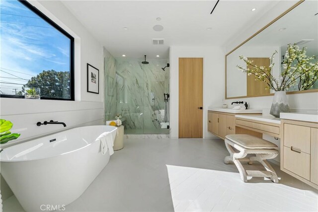 bathroom with concrete floors, shower with separate bathtub, and vanity