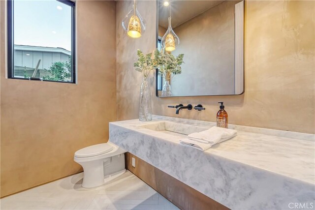 bathroom featuring toilet and sink