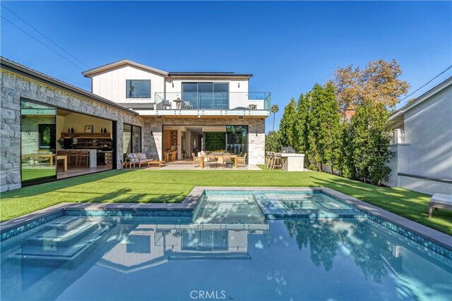 back of house featuring a yard, a patio area, and a balcony