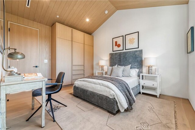 bedroom featuring high vaulted ceiling, wooden ceiling, and wooden walls