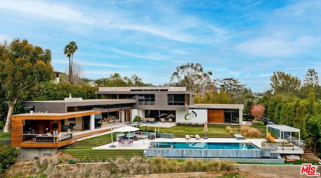 rear view of property featuring a patio area