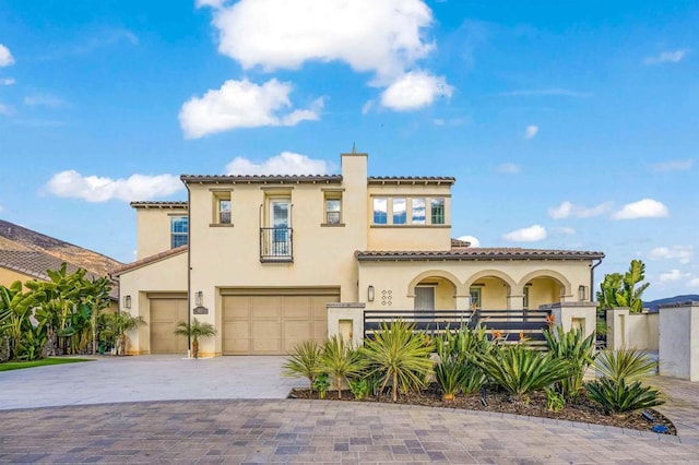 mediterranean / spanish-style home with a garage