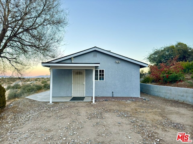 view of back house at dusk